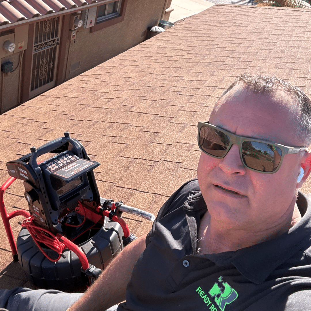 Ready Rooter technician Mike Topete running a drain machine on a tile roof vent