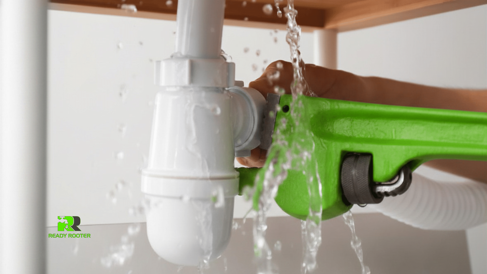 Gloved plumber's hands repairing a P-trap under a bathroom sink