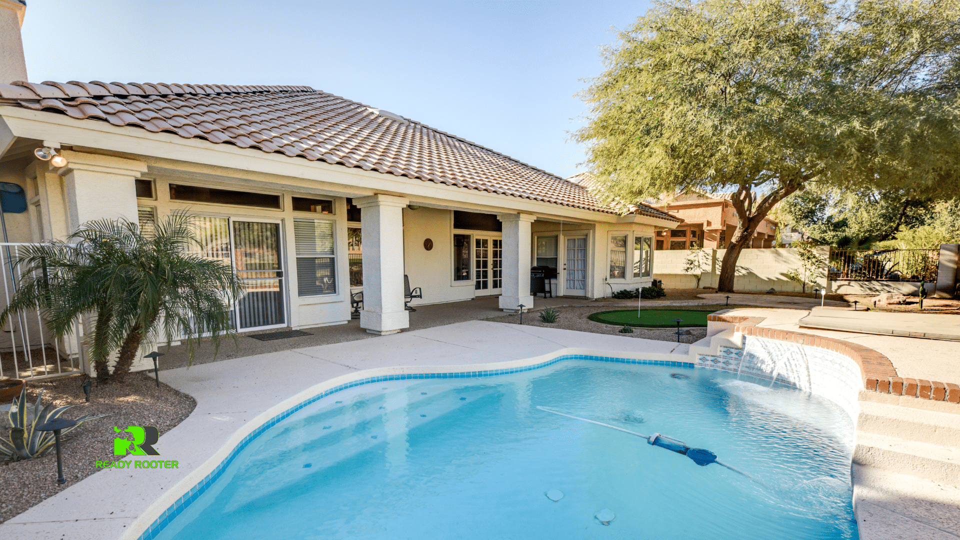 Arizona home with a tile roof and backyard swimming pool