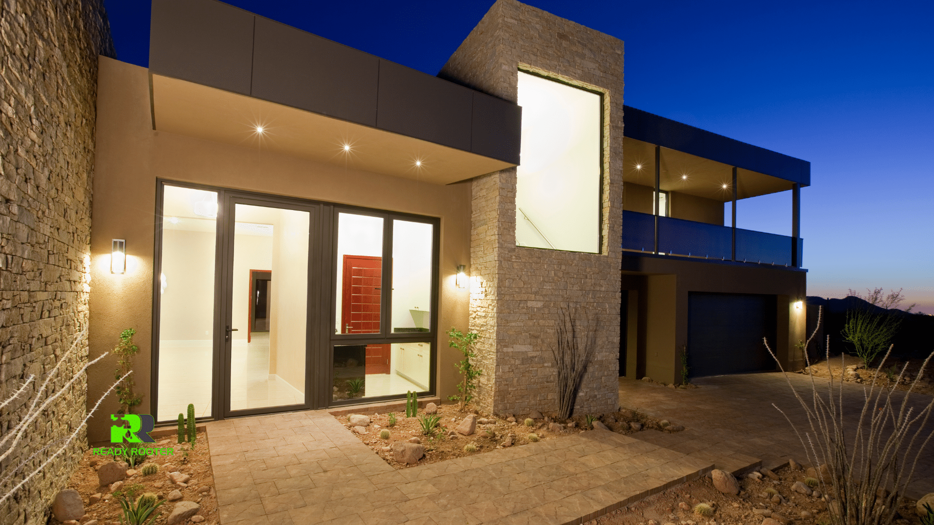 Modern Arizona home exterior with lit windows at dusk