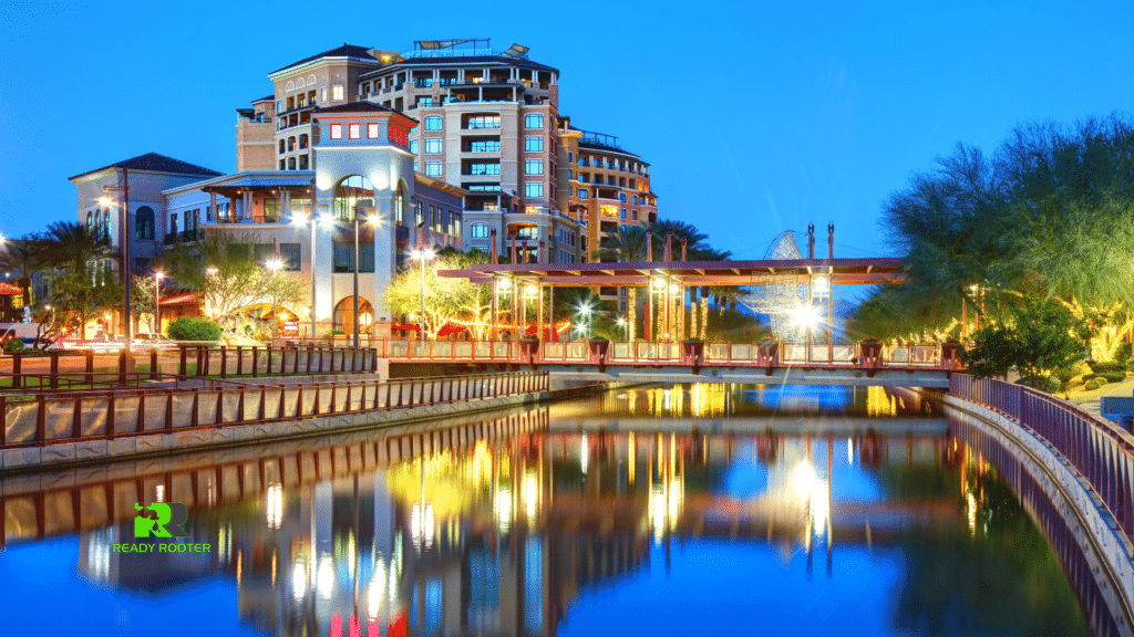 Scottsdale waterfront buildings lit at dusk reflecting in the Arizona Canal